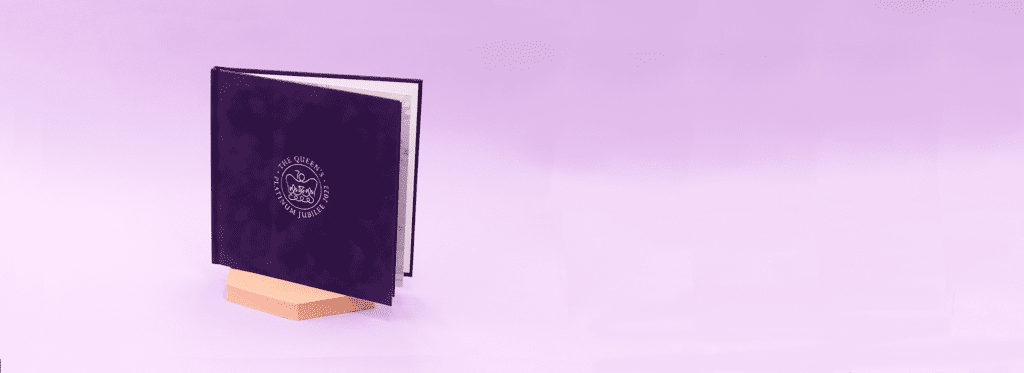 Display showing a single photobook with a suede Regal Jubilee pattern.